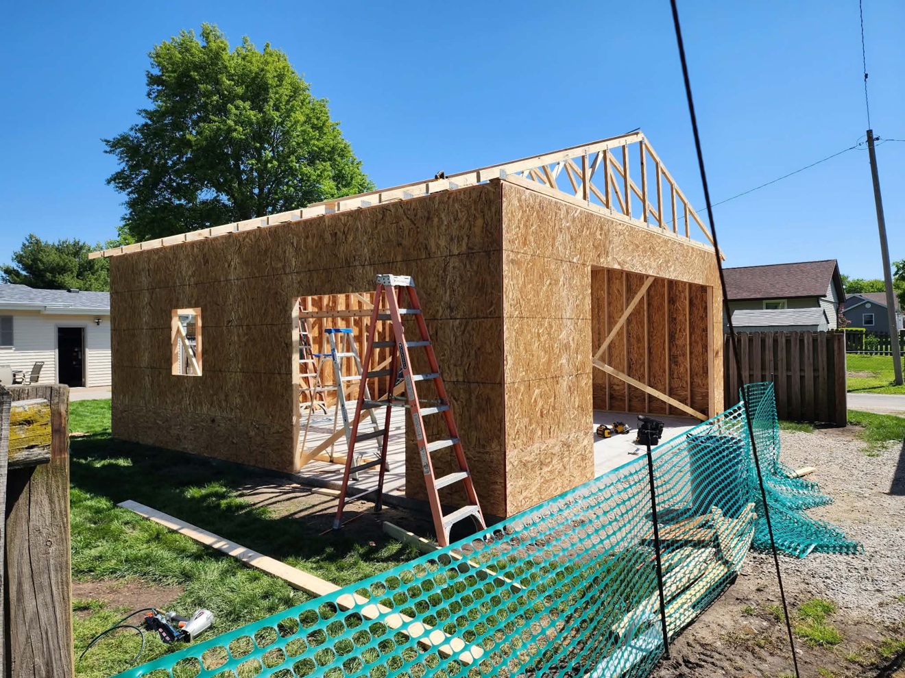 Wood-framed building addition with sheathing and roof trusses