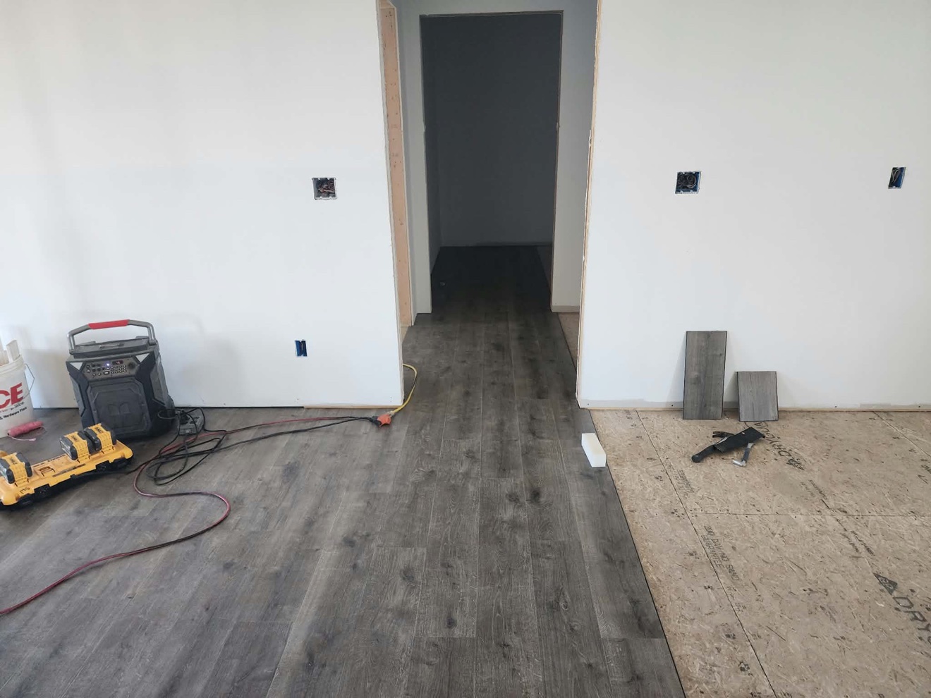 Gray wood-look plank flooring installed across a bright room