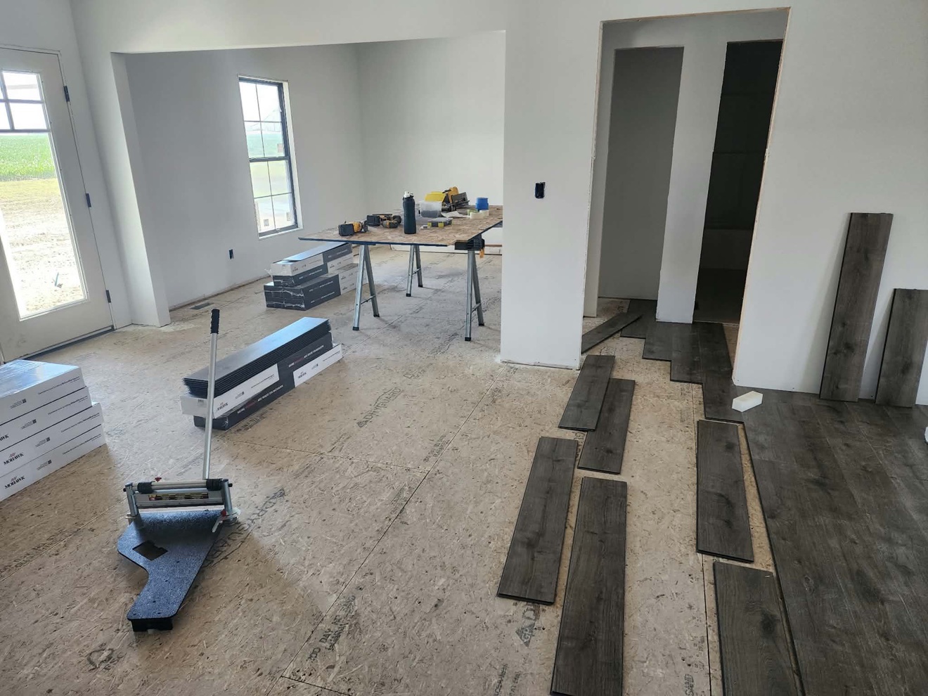 Room prepared for flooring with plank installation underway