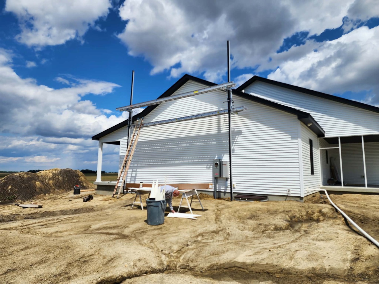 White single-story home exterior with new siding and covered porch