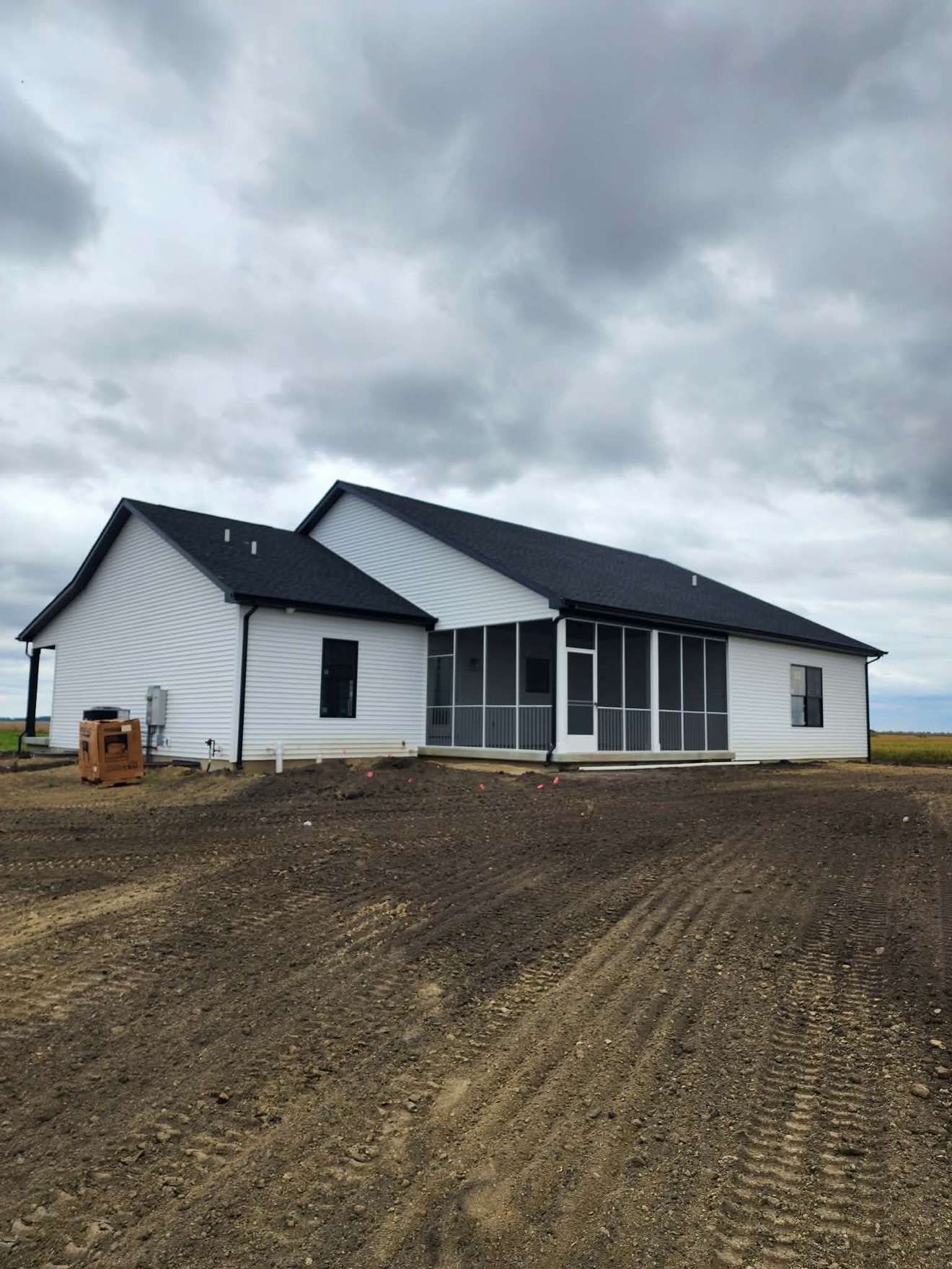 Completed single-story home with white siding and dark trim